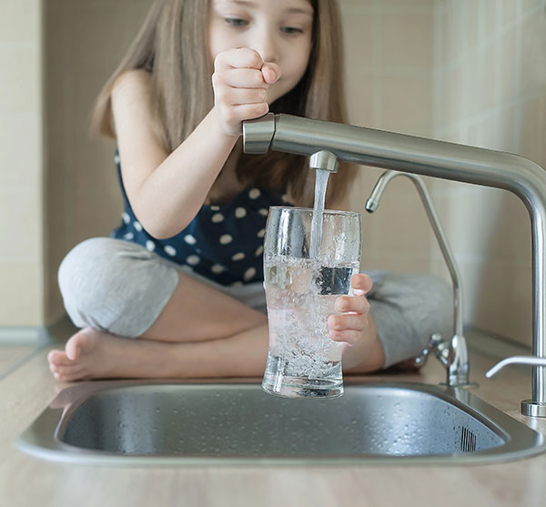 Little Girl Pouring Tap Water