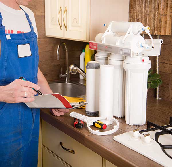 Technician Changing the water Filter Technician Changing the water Filter